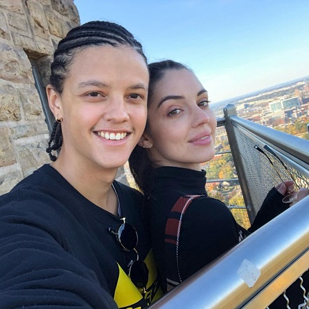 Adelaide Kane with her current boyfriend Jacques Colimon on a tower, taking a selfie.